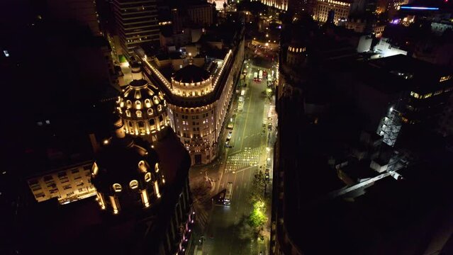 Aerial view of the illuminated domes of the Bencich Building and the ICBC in Buenos Aires at night.