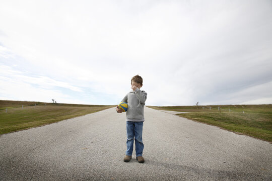 Boy Standing on Road