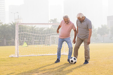 Senior friends playing football together.