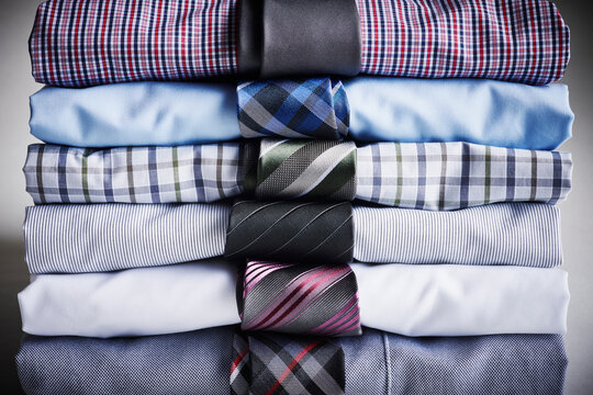 Close-up of stack of dress shirts with ties, studio shot