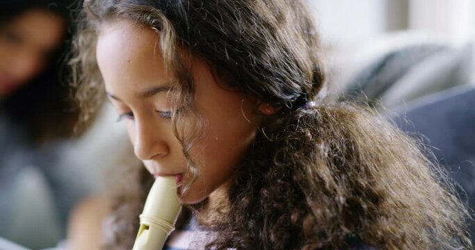 Child, flute and music class with teacher or instructor teaching kids for development. Musical instrument, learning notes and musician education or happy girl smile for talent performance at home