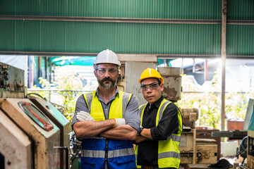 Engineer with monitor checking quality result of work. Man technician is working in a steel factory.