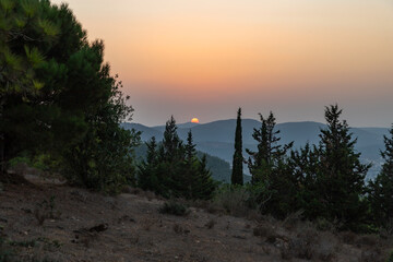Sunset  from the forested mountain on which it is located the Cave Church - Lavra Netofa monastery, near the Hararit village, in northern Israel