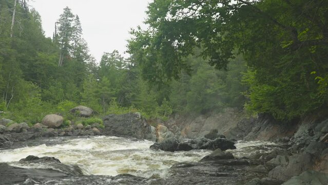 Tight shot of the Batchawana River flowing toward a waterfall, near the shore of Lake Superior in Ontario, Canada.  Shot in 4K