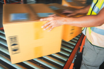 Motion Blurred of Worker Sorting Packaging Boxes on Conveyor Belt. Cartons, Cardboard Boxes. Storehouse. Distribution Warehouse. Shipping Supplies Warehouse. Cargo Shipment Transport Logistics.	