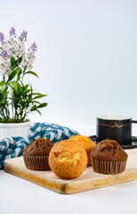 fresh muffins on wooden plate with coffee mug 
