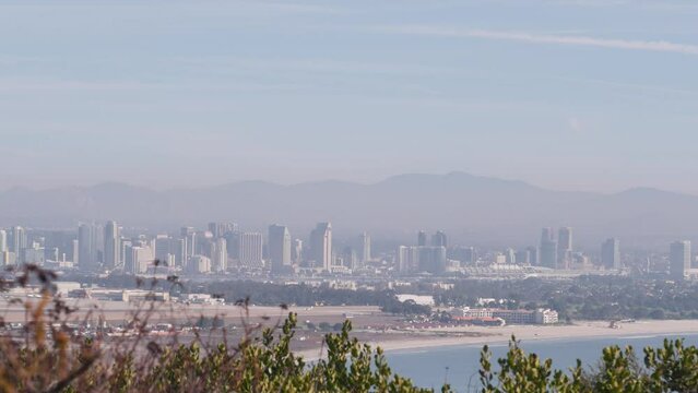 San Diego city skyline, cityscape of downtown with highrise skyscrapers, California coast, USA. View of Coronado island from above, Point Loma vista viewpoint. Airplane flying mid air in sky.