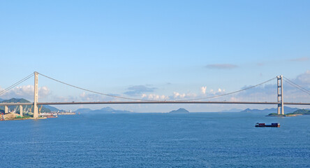 The Ting Kau car bridge in Hong Kong with clean blue sky and ocean