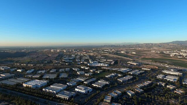 A daytime aerial flyover of the San Juan Capistrano area of southern California. Industrial office buildings and shopping plazas below. Helicopter GoPro footage.