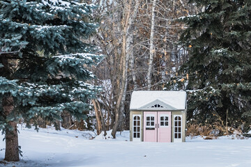 A shed with rose colored doors