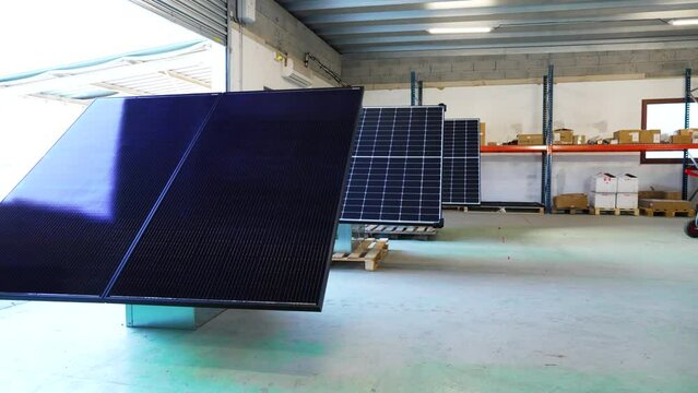 Electrician warehousewhere solar panels are being made ready for installation.