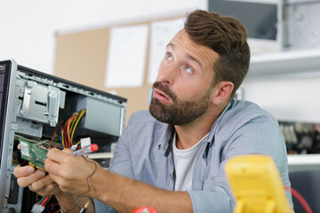 Fototapeta na wymiar a professional man repairing and assembling a computer