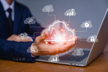 Hand of a businessman and big data analytics and business intelligence concept with chart and graph icons on digital screen interface. Cloud storage and working through digital with modern technology
