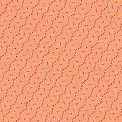 Modest white and brown polka dot diagonal border  isolated on a light orange, peach background