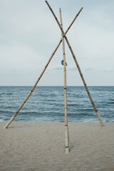 woods laying in triangle shape on the beach, boho vibe.