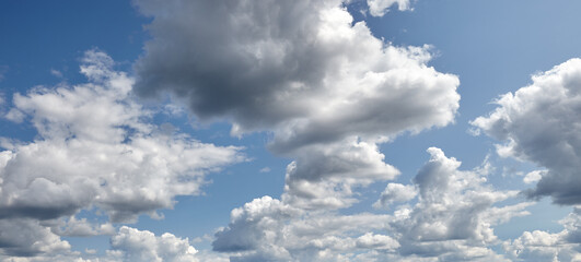 Panoramic photo of blurred sky. Blue sky background with cumulus clouds