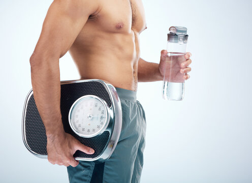 Man, water bottle or scale for body fitness, workout or training progress in healthcare wellness, diet control or muscle growth. Sports athlete, personal trainer or coach with weight scale or drink