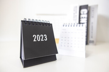 2023 business calendar on office table in new year day. Make a work plan for the start of the year. Concept about Celebration, Business, Christmas, New Year.
