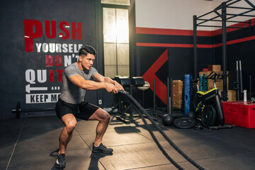 Obraz na płótnie Canvas Caucasian active handsome sportsman working out in fitness gym club. 
