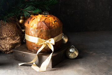 Italian Christmas cake, Panettoni  with raisins and candied fruits on wooden try with Christmas...