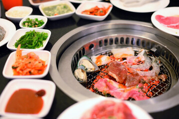 Raw food at grill with ingredients for BBQ