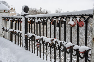fence on the embankment with locks on the main street of the city of Ryazan