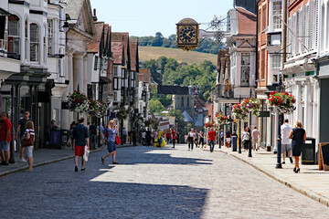 Guildford’s cobbled high street bustling with anonymised shops and shoppers