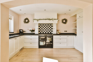 a kitchen with black and white checkered tiles on the walls, wood flooring and wooden floors in it