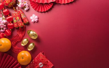 Chinese new year decorations made from red packet, orange and gold ingots or golden lump. Chinese characters FU on the object means to fortune, good luck, wealth, and money flow.