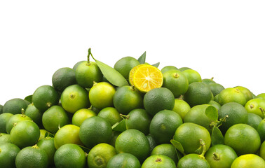 Many fresh ripe calamansi limes isolated on white background. Room for text.	