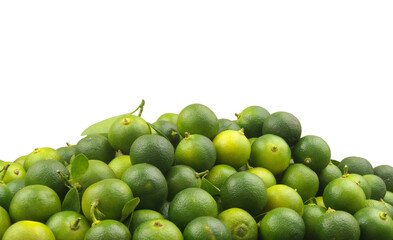Many fresh ripe calamansi limes isolated on white background. Room for text.	