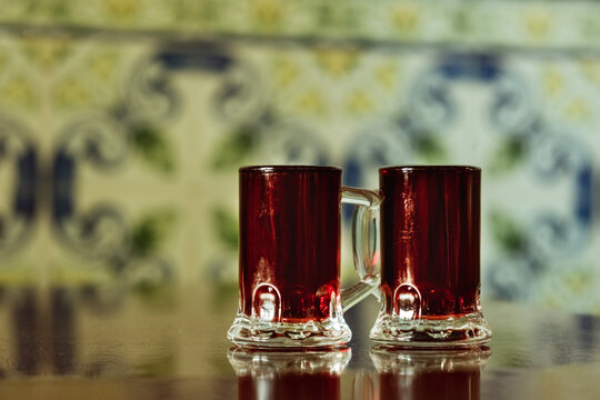 Ginjinha or Ginja - Portuguese liqueur made by infusing ginja berries sour cherry, Prunus cerasus austera, Morello cherry in alcohol aguardente and adding sugar. Selective focus