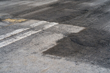 Motor road during preparatory work and partial removal of top layer for replacement and construction of new route. Old highway with white lines and ground surface prepared for laying new asphalt 
