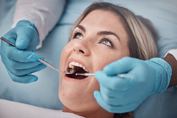 Dental, teeth and woman at the dentist for a check up, tooth whitening or cavity removal procedure. Dentistry, oral care and hands of a doctor checking the mouth of female patient with medical tools.