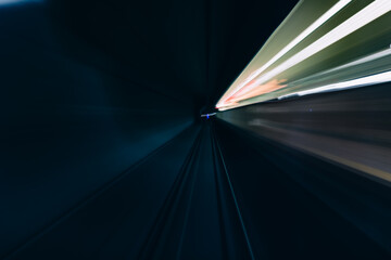 Long exposure shot of subway tunnel with blurry view.