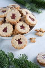 Shortcrust pastry Christmas cookies, Linzer cookies, biscuits with jam in the plate.
