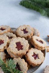 Shortcrust pastry Christmas cookies, Linzer cookies, biscuits with jam in the plate.