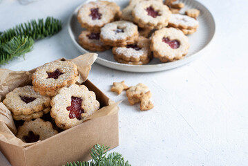 Shortcrust pastry Christmas cookies, Linzer cookies, biscuits with jam, plate and gift box.