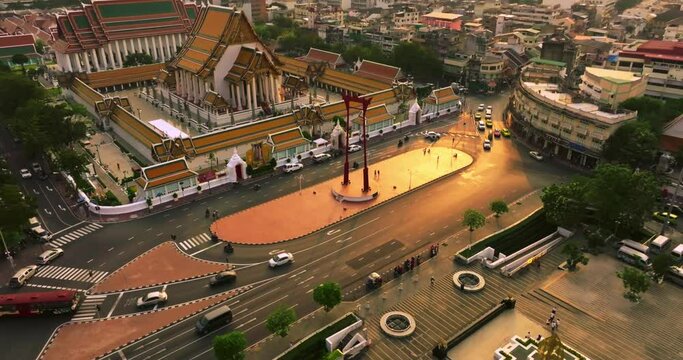 An aerial view of Red Giant Swing and Suthat Thepwararam Temple at sunset scene, The most famous tourist attraction in Bangkok, Thailand.