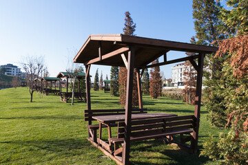 wooden arbor bench and table on the grass in the park