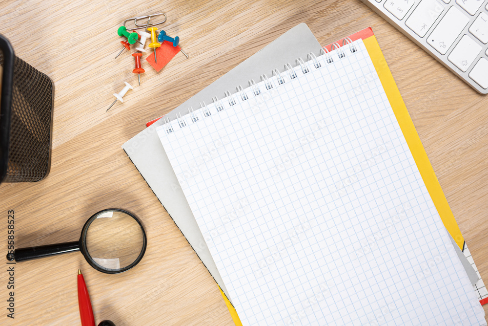 Poster Notebook mockup with school stationery on a wooden table. back to school concept. Blank notepad with copy space. list of goals and plans for new year 2023