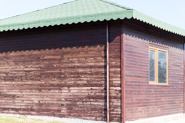 abandoned wooden house dirty window brown roof and sun