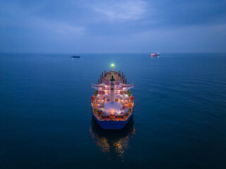 Aerial view cargo bulk carrier ship on the sea at night © sandsun