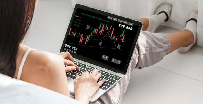 Successful of business trader investor woman use technology laptop trading graph of block chain stock market cryptocurrency investment selling and buy with price chart data graph