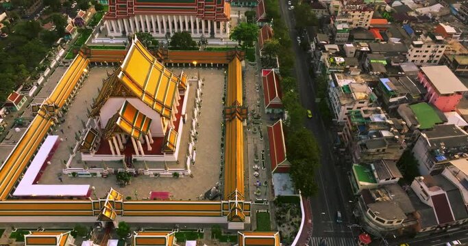 An aerial view of Red Giant Swing and Suthat Thepwararam Temple at sunset scene, The most famous tourist attraction in Bangkok, Thailand.