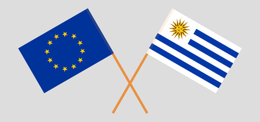 Crossed flags of the European Union and Uruguay. Official colors. Correct proportion