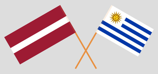 Crossed flags of Latvia and Uruguay. Official colors. Correct proportion
