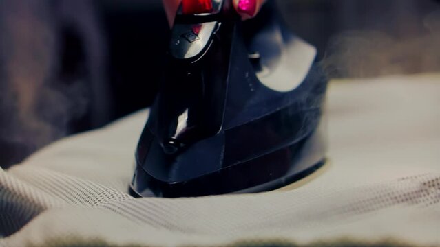 woman ironing clothes on ironing board .