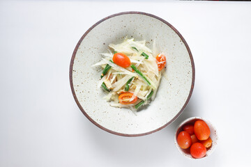 Som Tum is Thai Green Papaya Salad, served in a bowl.