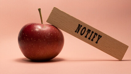 The word notify. Written on wooden frame. Studio shoot.